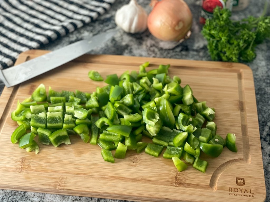 chopped green bell peppers on a cutting board