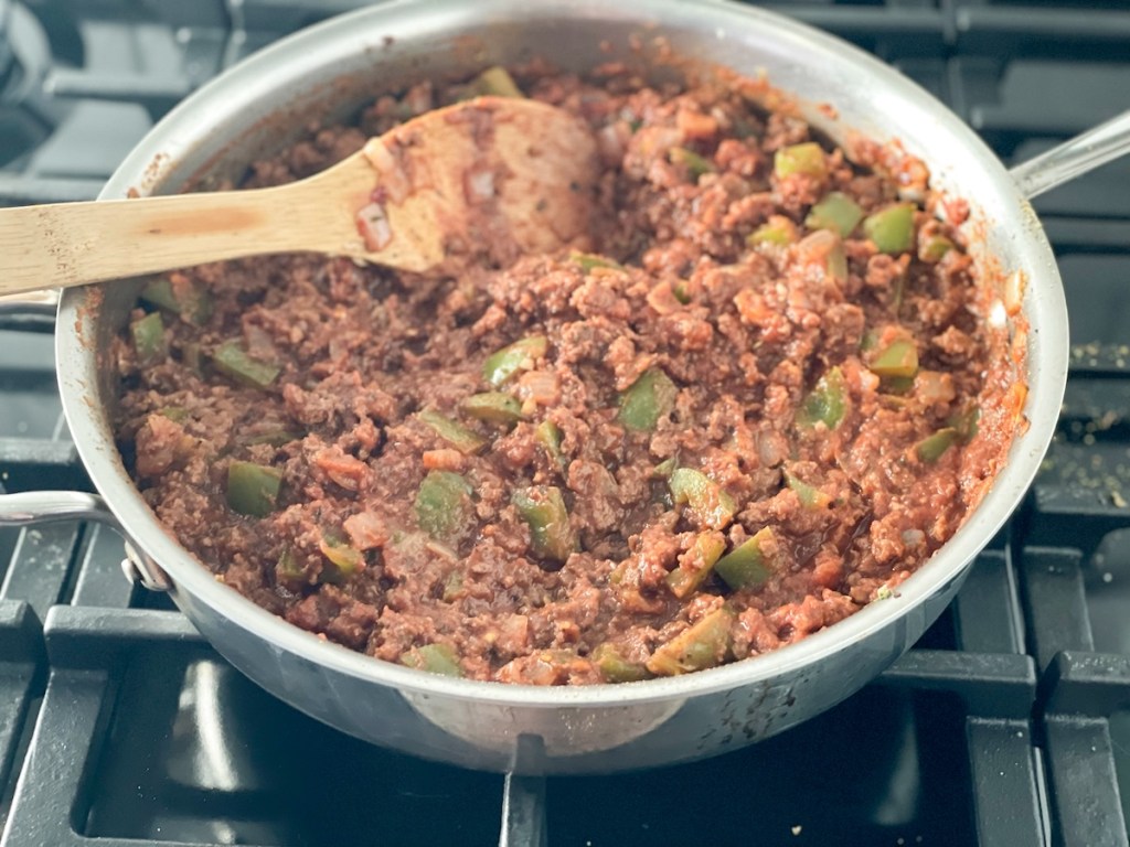 skillet with tomato sauce, ground beef, and veggies