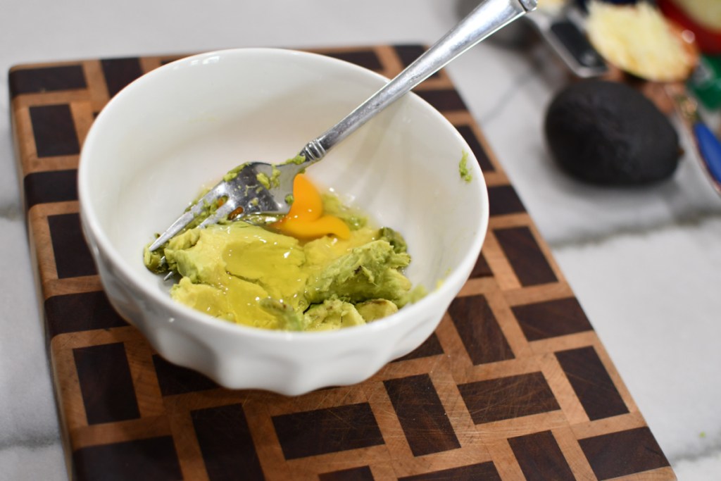 bowl with ripe avocado and egg
