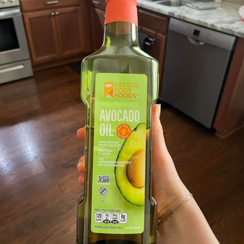 holding a bottle of avocado oil
