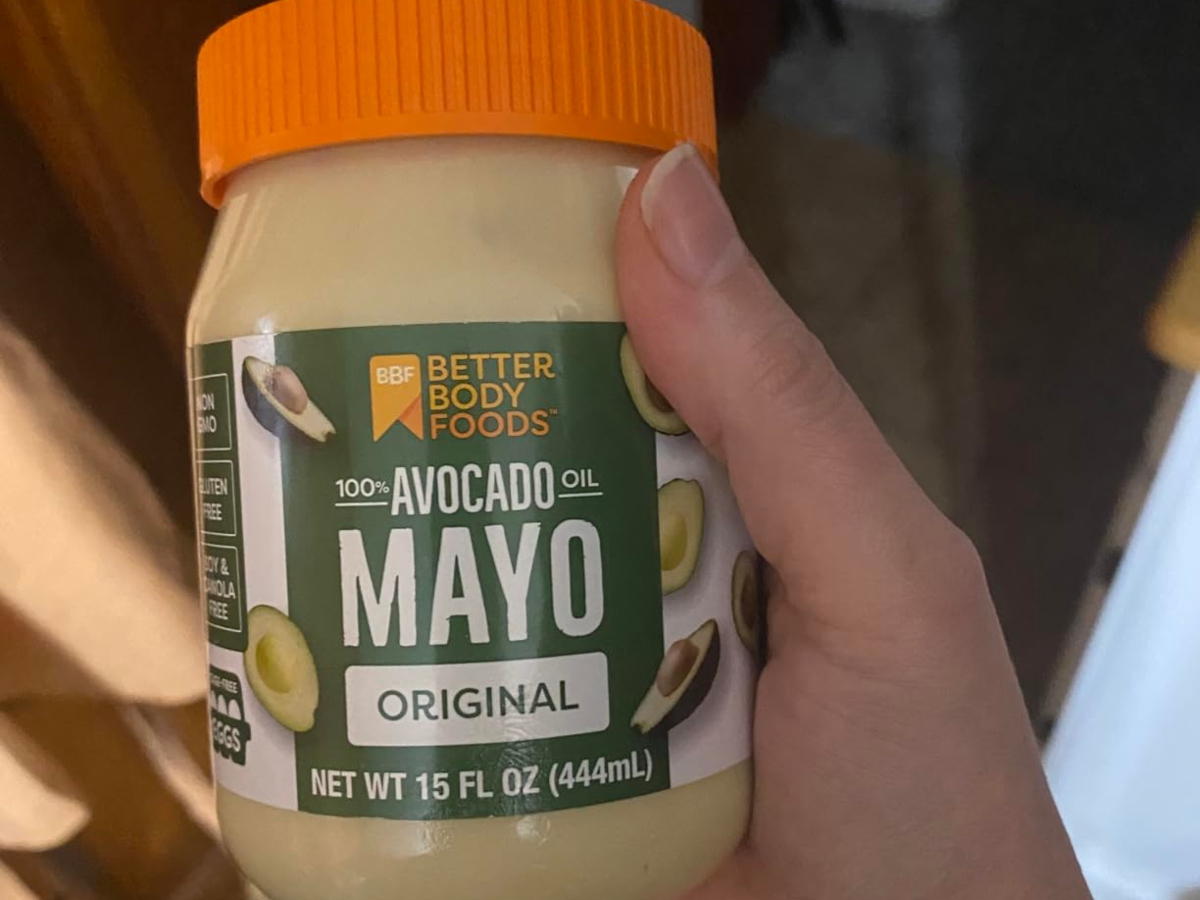 holding a jar of avocado mayonnaise