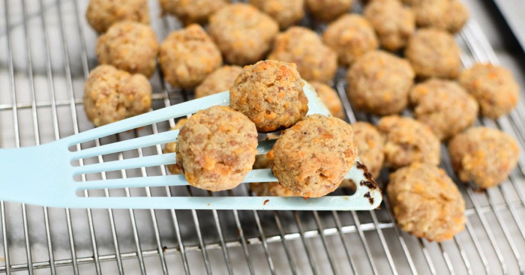 keto sausage balls on a spatula after baking