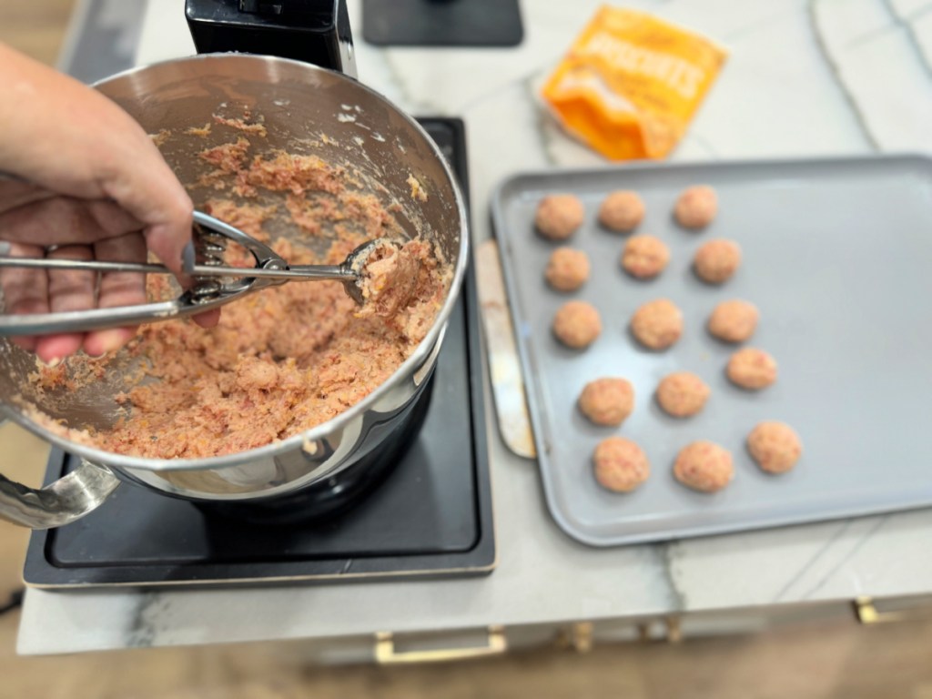 using a small cookie scoop to form sausage balls