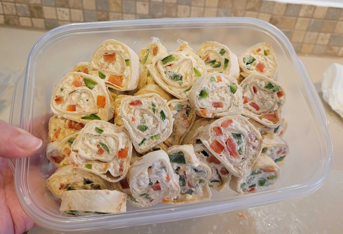 keto pinwheels in a tupperware container for christmas