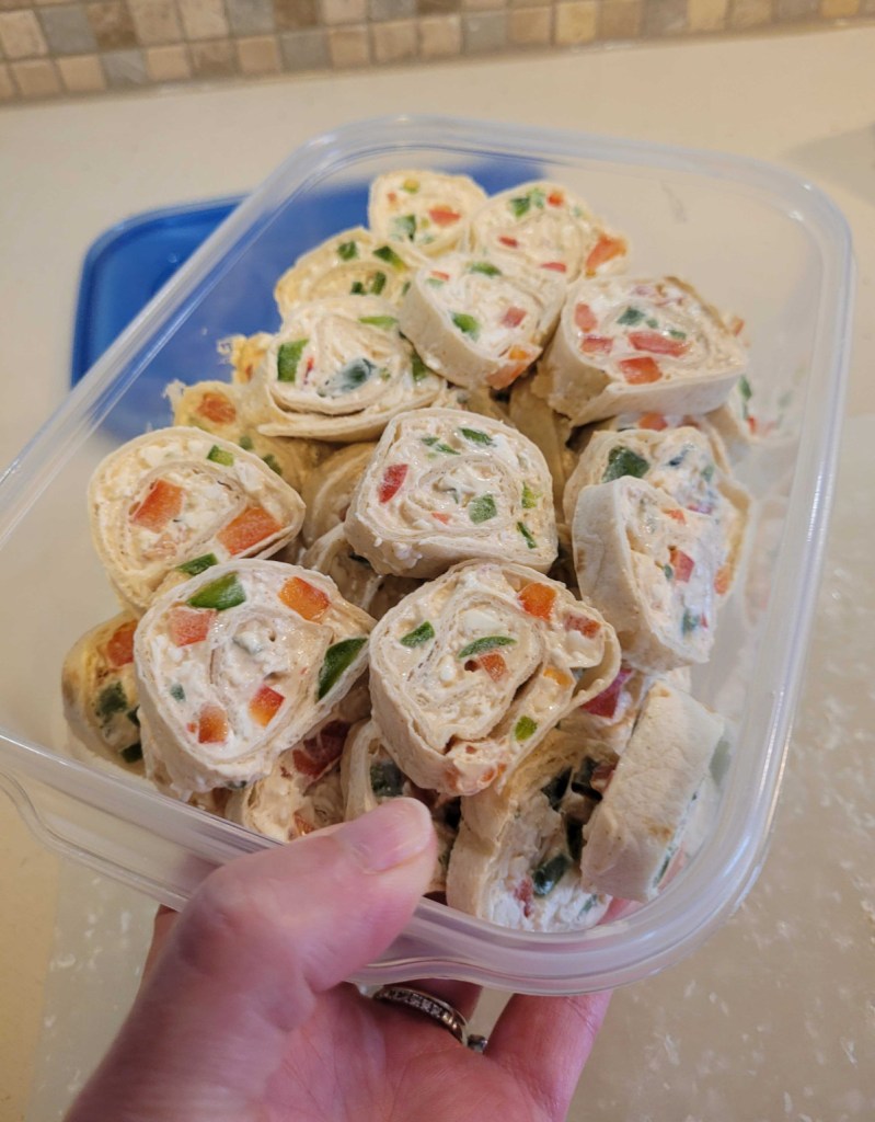 tupperware container with keto pinwheels