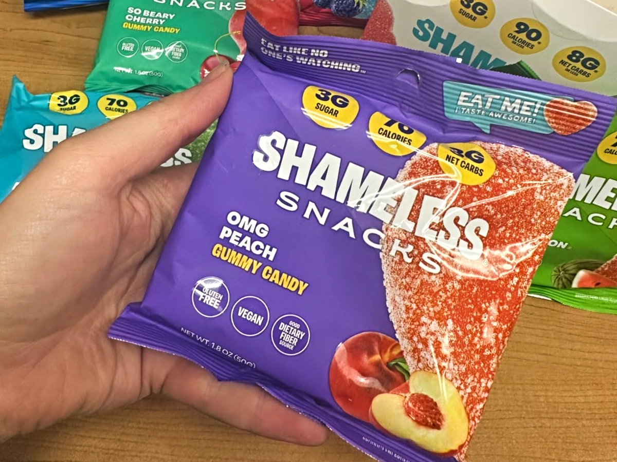 holding a bag of keto gummies