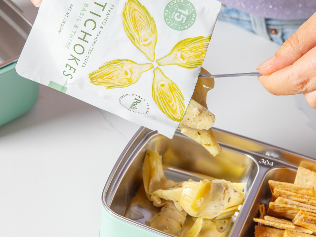 emptying package of artichokes into a metal tray