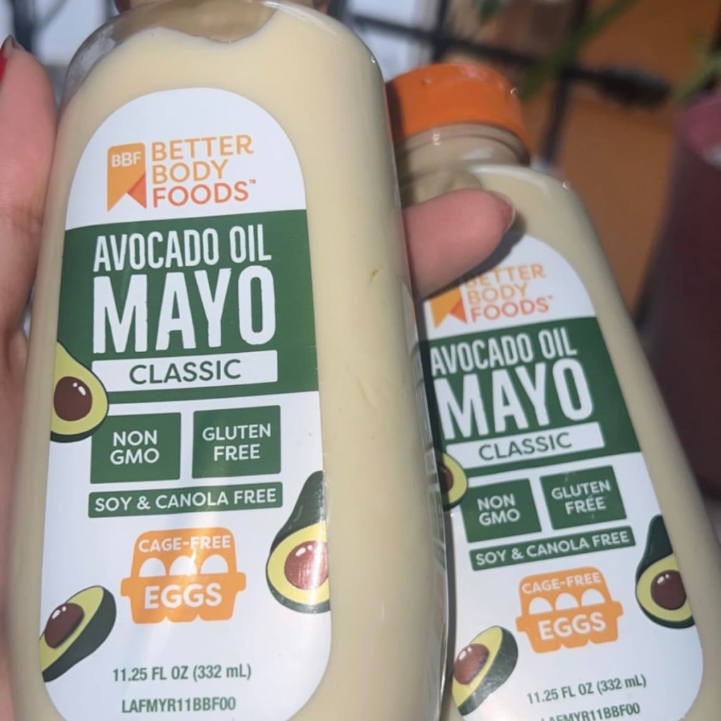 holding 2 bottles of mayonnaise