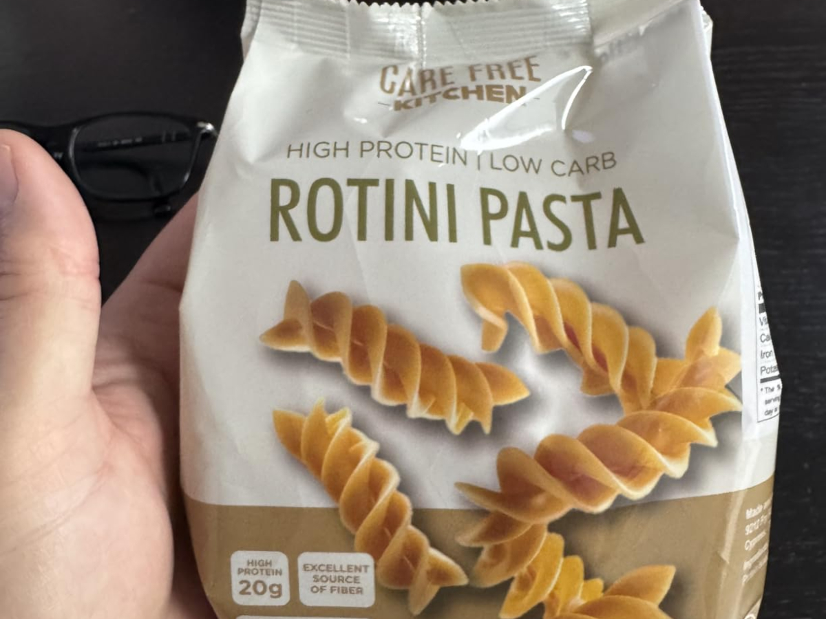 holding a bag of keto rotini pasta